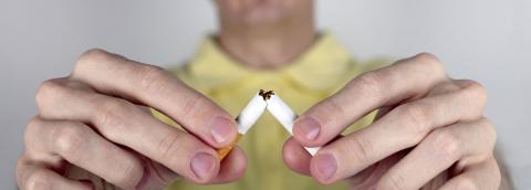 man breaking cigarette image