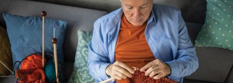 man relaxed while knitting