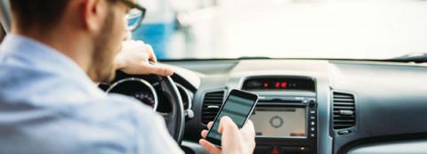 man using cell phone in car