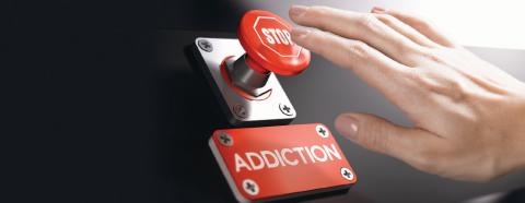 hand pushing stop addiction button