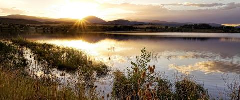 Sun setting over a rural scene